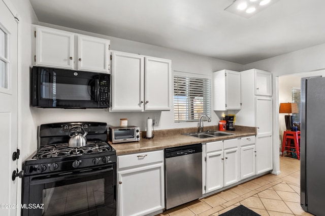 kitchen featuring sink, white cabinets, and black appliances