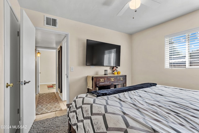 tiled bedroom with ceiling fan