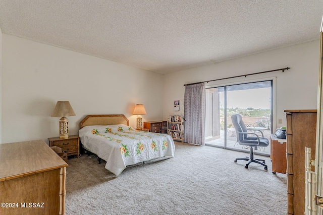 carpeted bedroom featuring a textured ceiling and access to outside