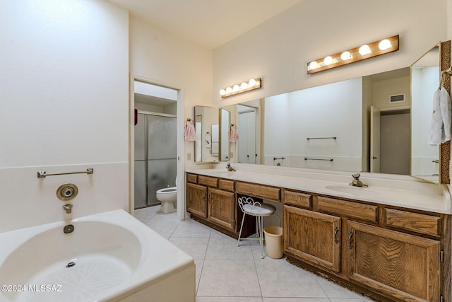 full bathroom featuring toilet, vanity, tile patterned flooring, and separate shower and tub