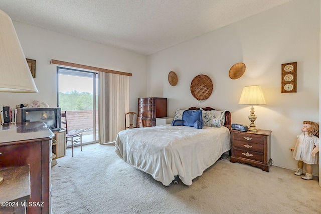 bedroom with access to exterior, light colored carpet, and a textured ceiling