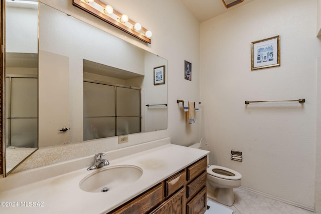 bathroom featuring vanity, walk in shower, tile patterned flooring, and toilet