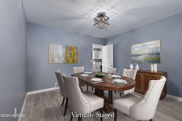 dining space with hardwood / wood-style floors