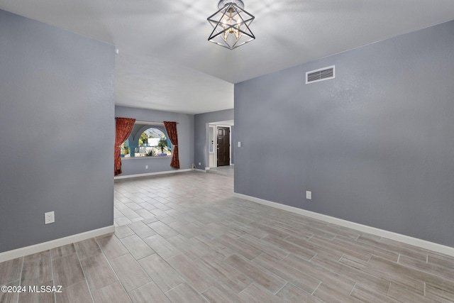 interior space with light wood-type flooring and a notable chandelier