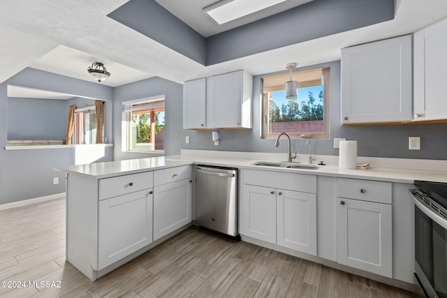 kitchen with stainless steel appliances, white cabinetry, hanging light fixtures, sink, and kitchen peninsula