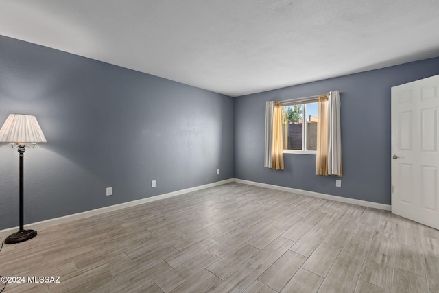 empty room with light wood-type flooring