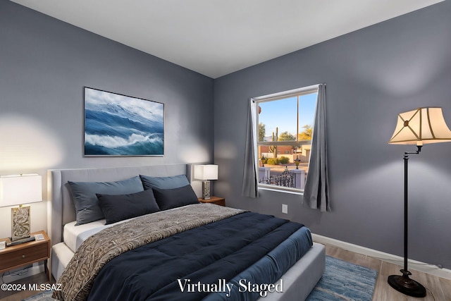 bedroom with hardwood / wood-style floors