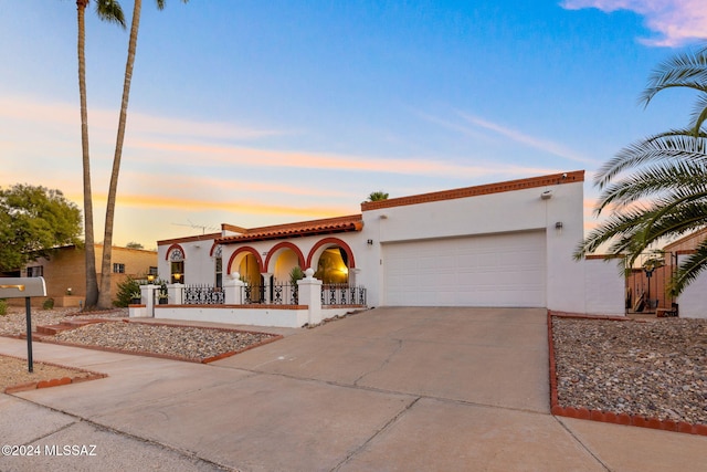 mediterranean / spanish-style home featuring a garage