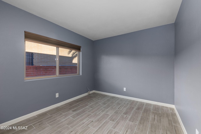 unfurnished room with light wood-type flooring