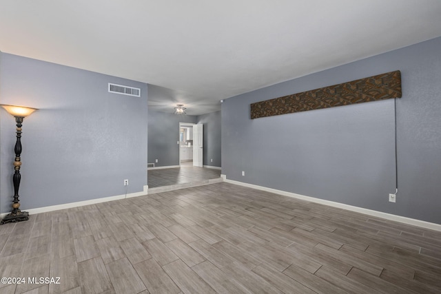 unfurnished room with hardwood / wood-style floors