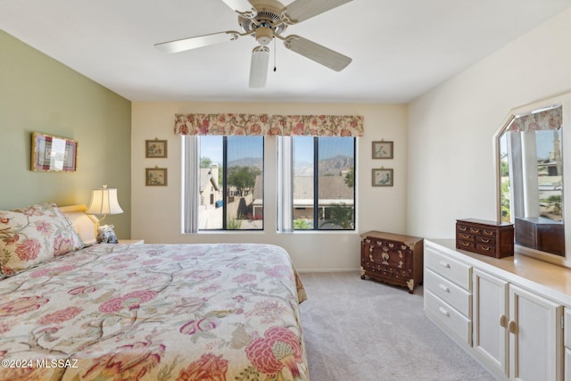 bedroom featuring light carpet and ceiling fan