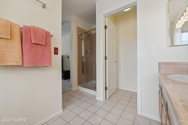 full bathroom with tile patterned floors, a shower stall, baseboards, and vanity