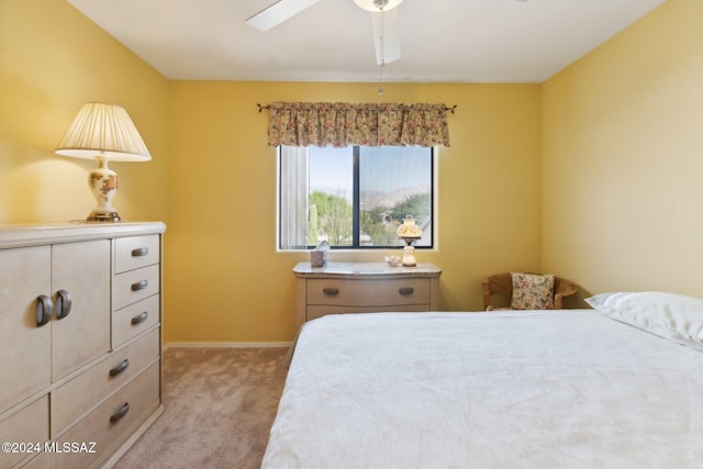 bedroom with a ceiling fan, light colored carpet, and baseboards