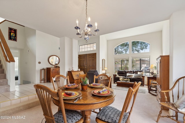 dining area with light tile patterned floors, light carpet, a towering ceiling, stairs, and an inviting chandelier