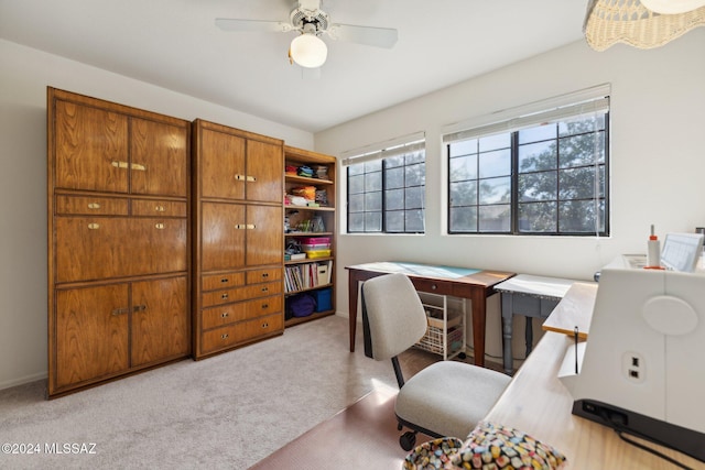 office area featuring a ceiling fan, a wealth of natural light, and light carpet