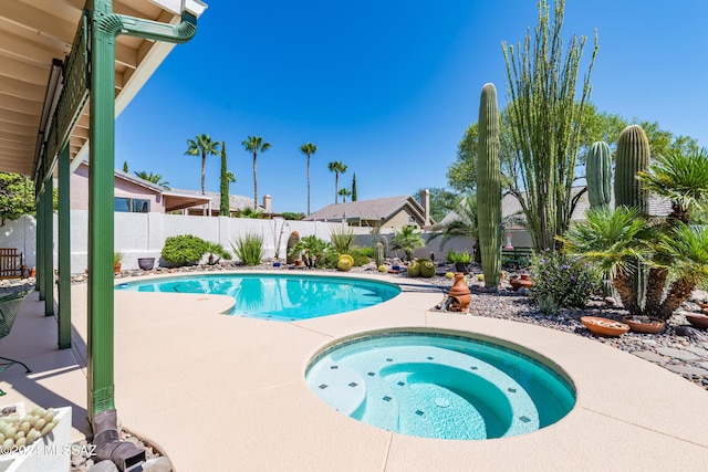 view of swimming pool featuring an in ground hot tub, a patio area, a fenced backyard, and a fenced in pool