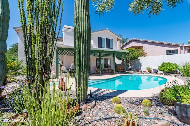 view of swimming pool featuring a fenced in pool, a patio area, and fence