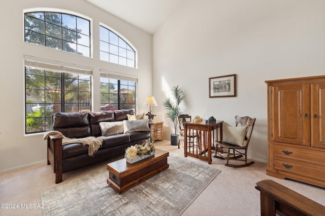 living room with light carpet and high vaulted ceiling