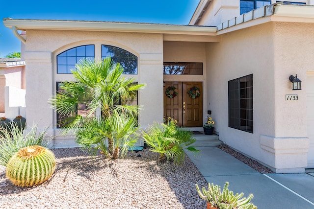 property entrance featuring stucco siding