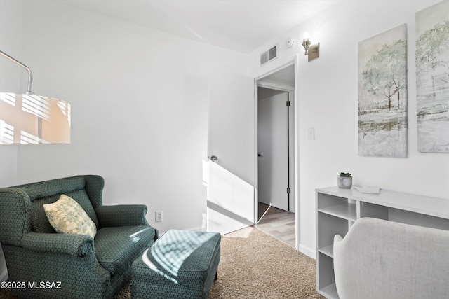 living area with light colored carpet