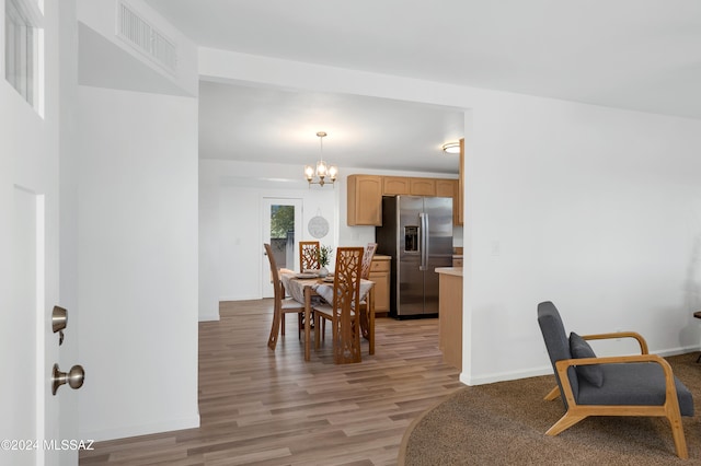 dining area featuring a notable chandelier and light hardwood / wood-style flooring