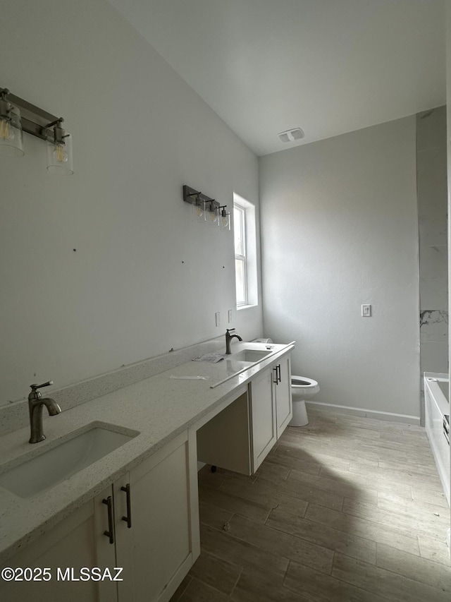 full bathroom with toilet, a washtub, visible vents, and a sink