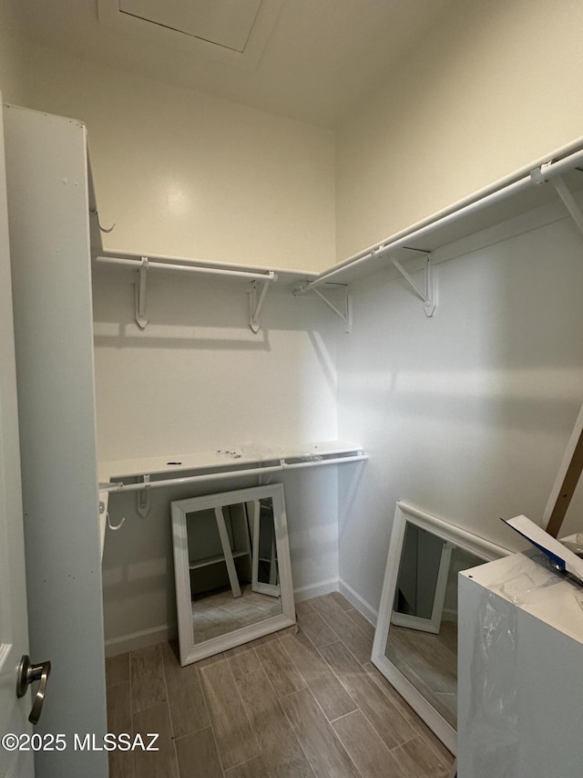 spacious closet featuring wood finish floors