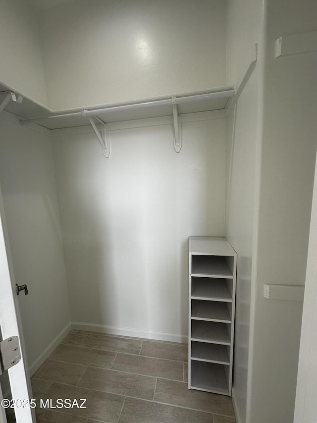 spacious closet with wood tiled floor