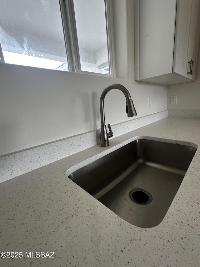 room details with gray cabinetry and a sink