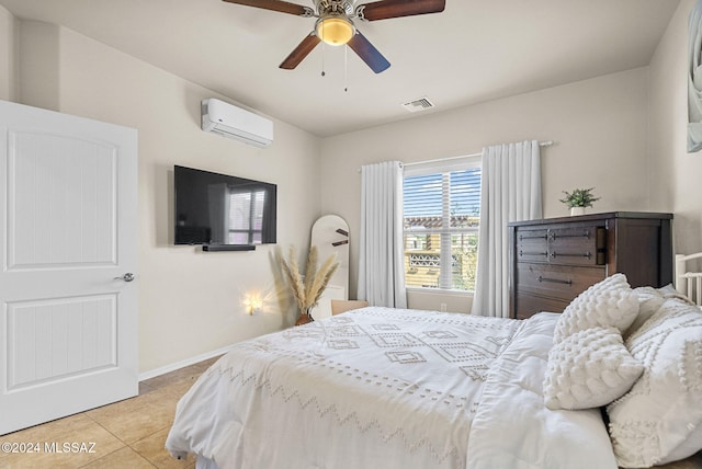bedroom featuring light tile patterned floors, ceiling fan, and a wall mounted air conditioner