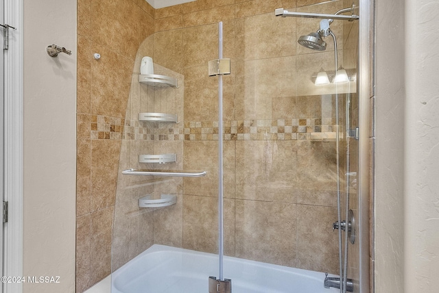 bathroom featuring shower / bath combination with glass door
