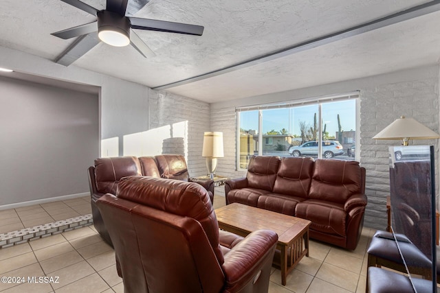 cinema with light tile patterned floors, ceiling fan, and brick wall