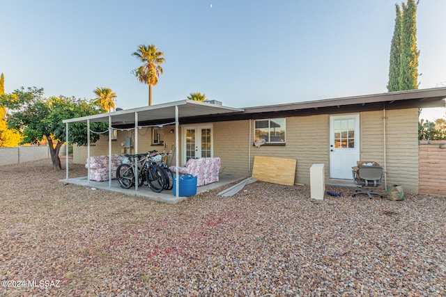 back of property with french doors and a patio area