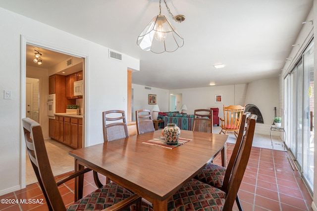 dining room featuring a notable chandelier and tile patterned floors