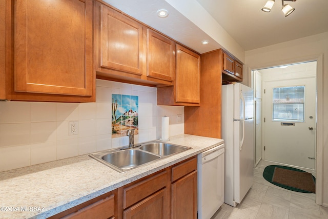 kitchen featuring decorative backsplash, white appliances, sink, and light tile patterned floors