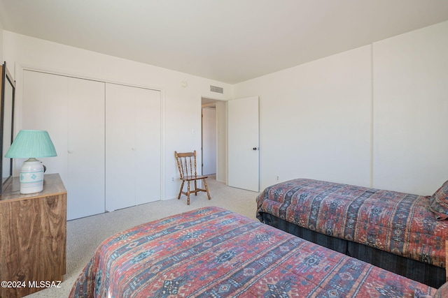 carpeted bedroom featuring a closet