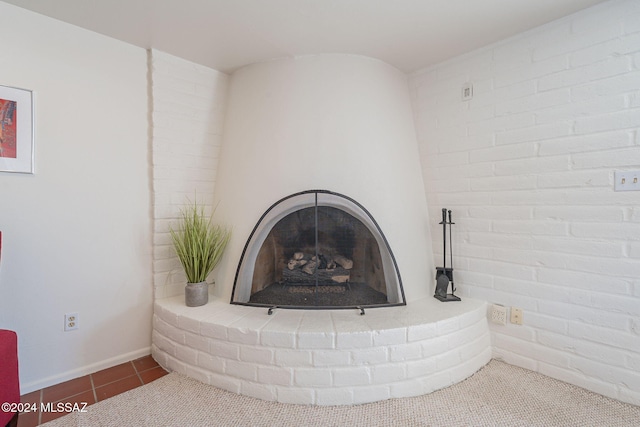 room details featuring a fireplace and tile patterned floors