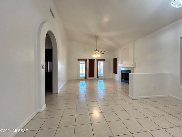 interior space featuring vaulted ceiling, ceiling fan, and light tile patterned flooring