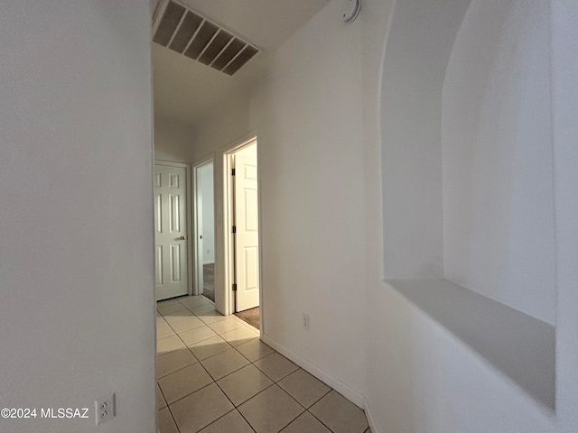 hall featuring light tile patterned floors