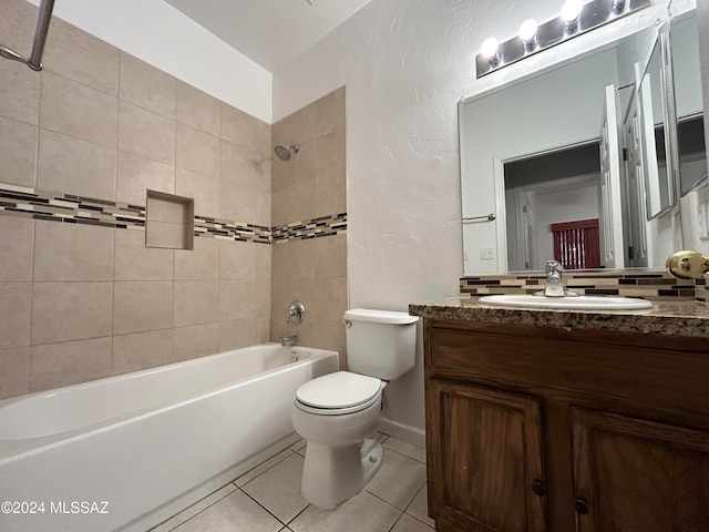 full bathroom featuring tile patterned flooring, vanity, tiled shower / bath combo, and toilet