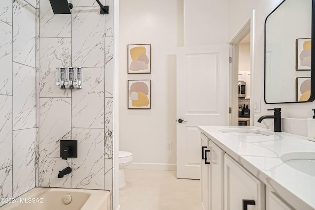 full bathroom with toilet, tiled shower / bath combo, and vanity