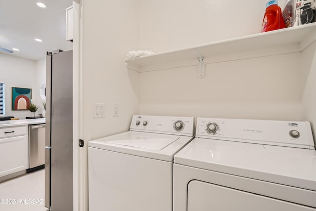 laundry room featuring washing machine and clothes dryer