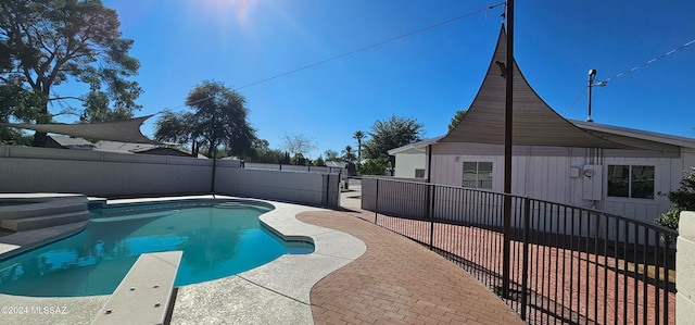 view of swimming pool featuring a diving board and a patio area