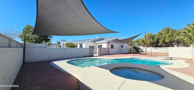 view of swimming pool with an in ground hot tub and a patio area