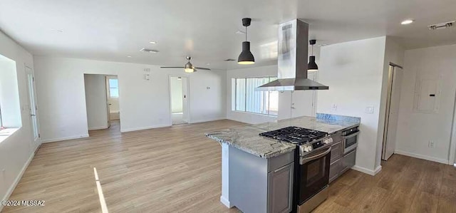 kitchen with island exhaust hood, appliances with stainless steel finishes, ceiling fan, and light hardwood / wood-style flooring