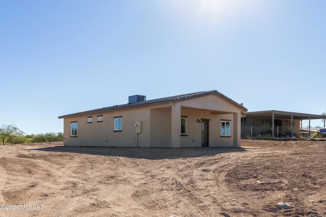 back of house featuring central AC