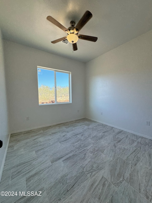 empty room featuring ceiling fan