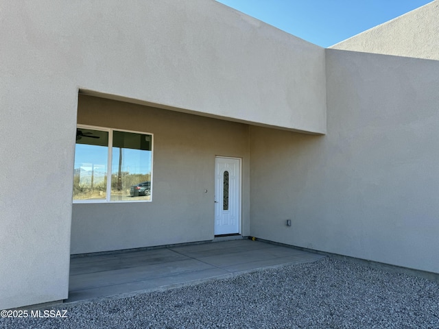 view of exterior entry featuring a patio