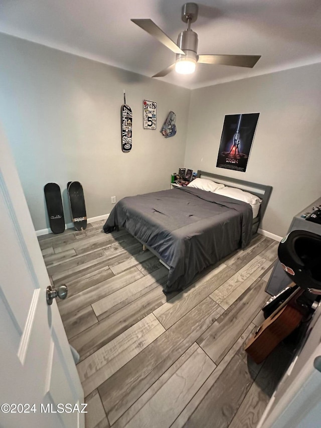 bedroom with hardwood / wood-style floors and ceiling fan