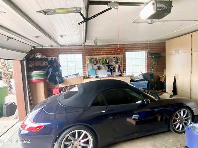 garage with a workshop area and a garage door opener